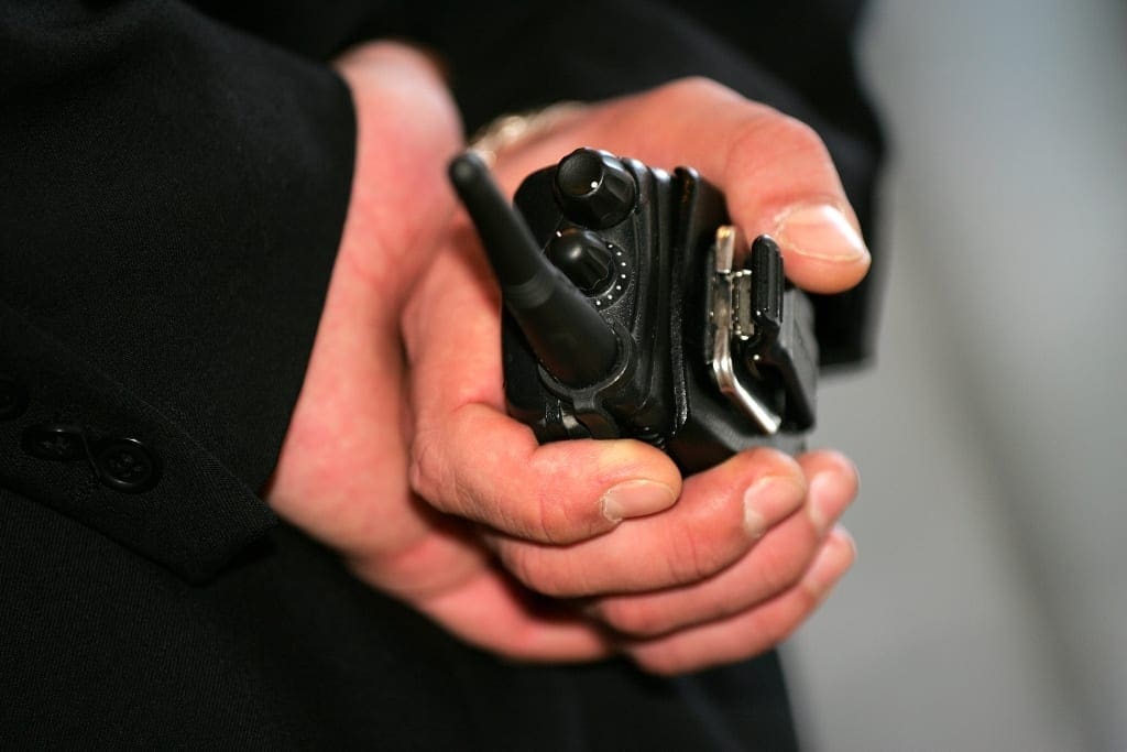 hands with walkie talkie - manned guarding