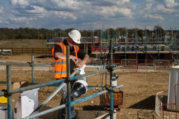 CCTV Engineer installing camera on construction site