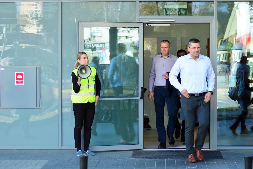 Trained Fire Warden Evacuating Corporate Building